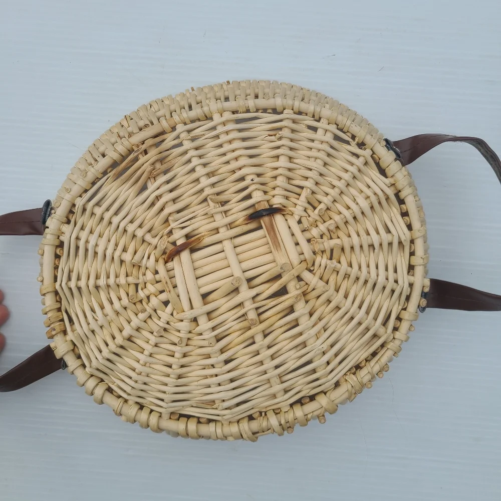 Woven wicker basket with faux leather handles